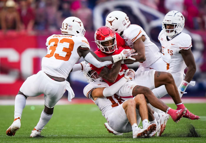 The Texas defense bring down Houston wide receiver Matthew Golden (2) in the fourth quarter of the Longhorn's game against the Houston Cougars at TDECU Stadium in Houston, Saturday, Oct. 21, 2023. Texas won the game 31-24.